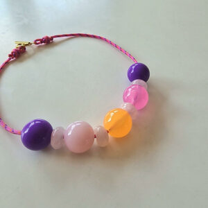 zoom sur le collier NOUMEA, avec ses perles acidulées violettes, rose et orange